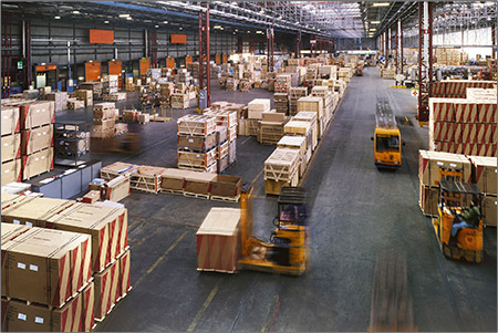 Transporters moving around in a warehouse carrying boxes